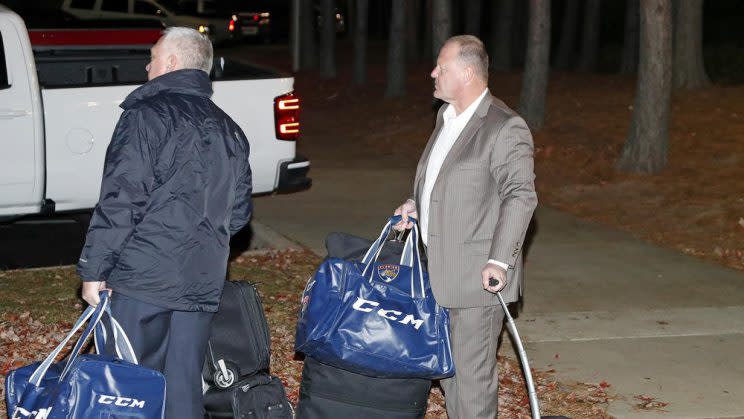 Gerard Gallant, right, former Florida Panthers head coach, waits for a cab after being relieved of his duties following an NHL hockey game against the Carolina Hurricanes, Sunday, Nov. 27, 2016, in Raleigh, N.C. (AP Photo/Karl B DeBlaker)