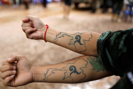 Soldiers display tattooos near the Tham Luang cave complex, where 12 schoolboys and their soccer coach are trapped inside a flooded cave, in the northern province of Chiang Rai, Thailand, July 7, 2018. REUTERS/Soe Zeya Tun