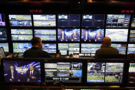 Producer Robert Hyland, left, and director Drew Esocoff work inside the NBC Sports trailer in preparation for the network's "Sunday Night Football" broadcast of NFL game between the Los Angeles Chargers and the Miami Dolphins on Dec. 11, 2022, in Inglewood, Calif. “Sunday Night Football” is on pace to be prime time's top show for the 12th consecutive year. (AP Photo/Jae C. Hong)