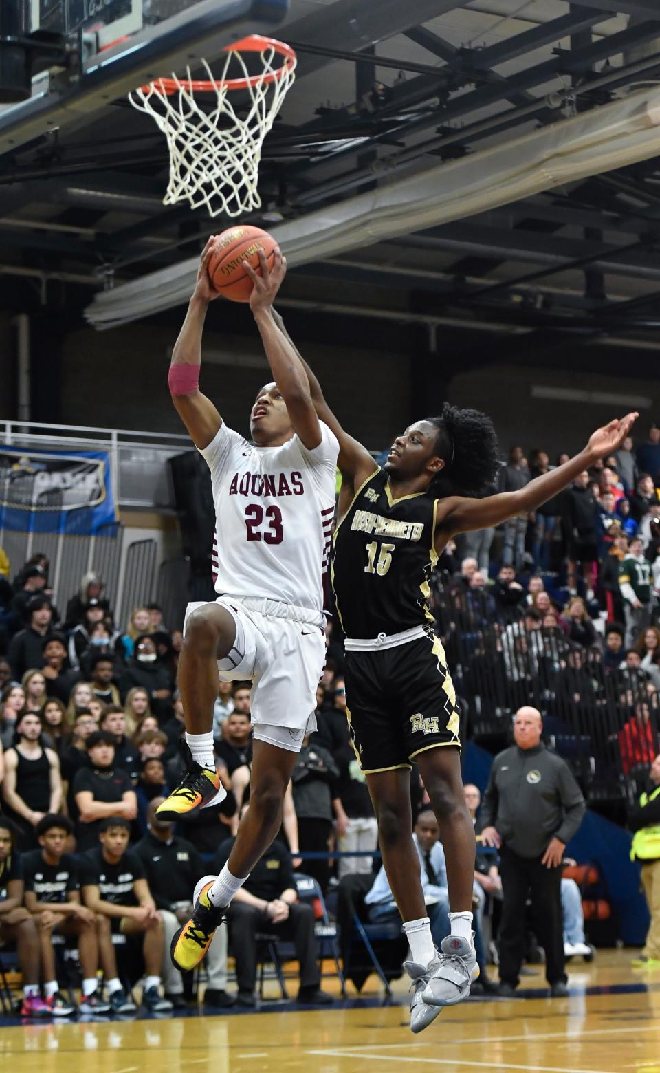 Aquinas' Myles Blackwood, left, drives to the basket against R-H’s Abdulfatah Bori during the Section V Class AA Championship at Gates Chili High School, Saturday, March 5, 2022. No. 2 seed Aquinas No. 8 seed Rush-Henrietta.