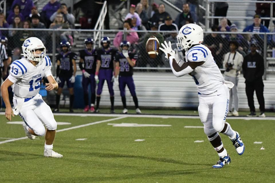 Gibraltar Carlson quarerback Joe Krolak (left) pitches the ball to Izaiah Wright during a 31-8 win over Woodhaven Friday night.