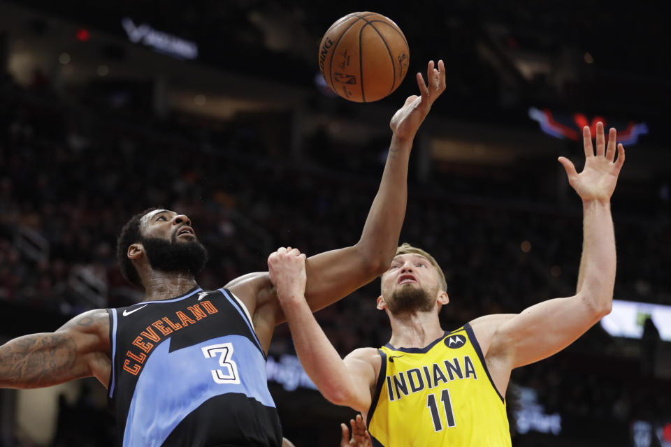 Cleveland Cavaliers' Andre Drummond (3) and Indiana Pacers' Domantas Sabonis (11) battle for a loose ball in the second half of an NBA basketball game, Saturday, Feb. 29, 2020, in Cleveland. Indiana won 113-104. (AP Photo/Tony Dejak)