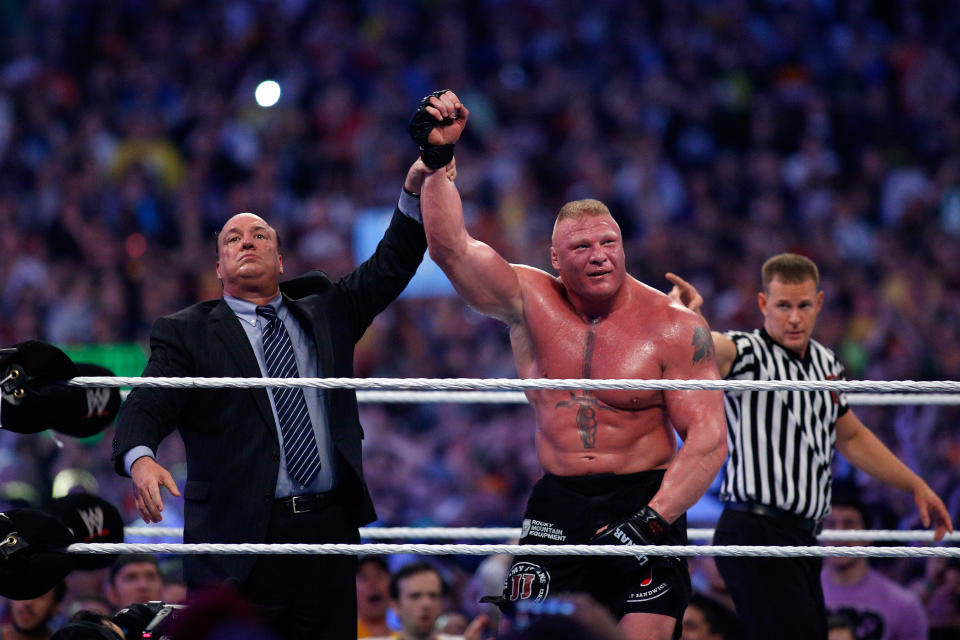 Paul Heyman, left, celebrates with Brock Lesnar after his win over the Undertaker during Wrestlemania XXX at the Mercedes-Benz Super Dome in New Orleans on Sunday, April 6, 2014. (Jonathan Bachman/AP Images for WWE)