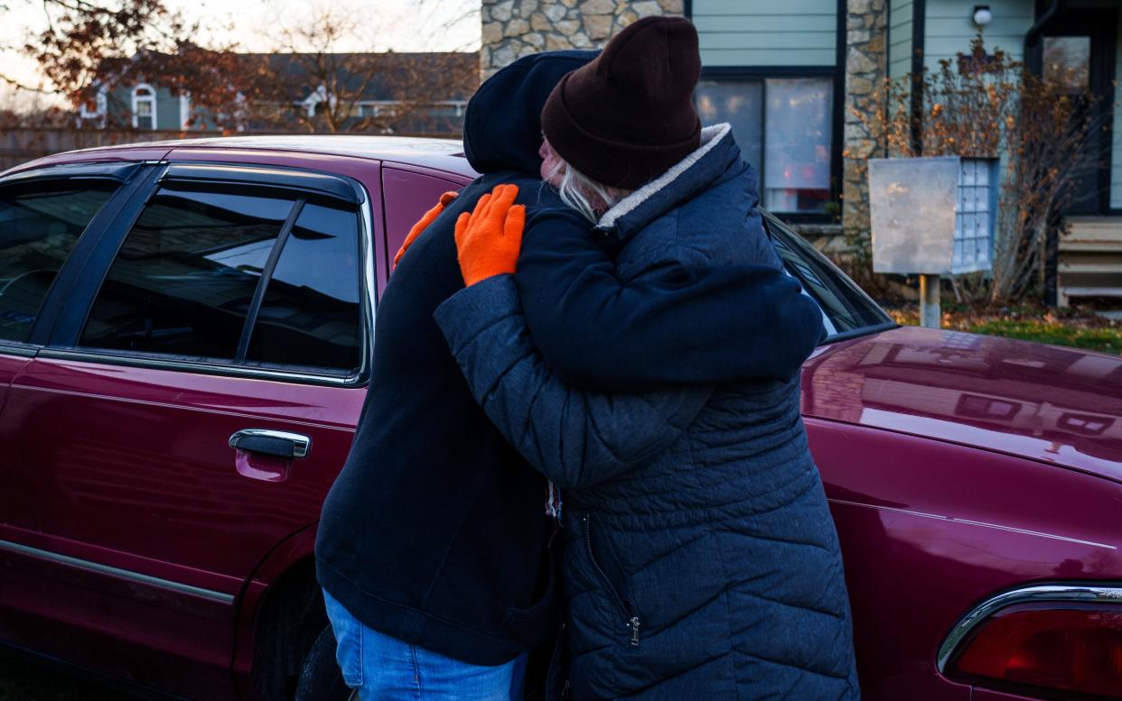 Reeda Raney is given a hug Monday, Nov. 27, 2023, from her mother, Glenda Dillon, as Raney and friend Austin Jensen move their belongings out of their apartment after being evicted.