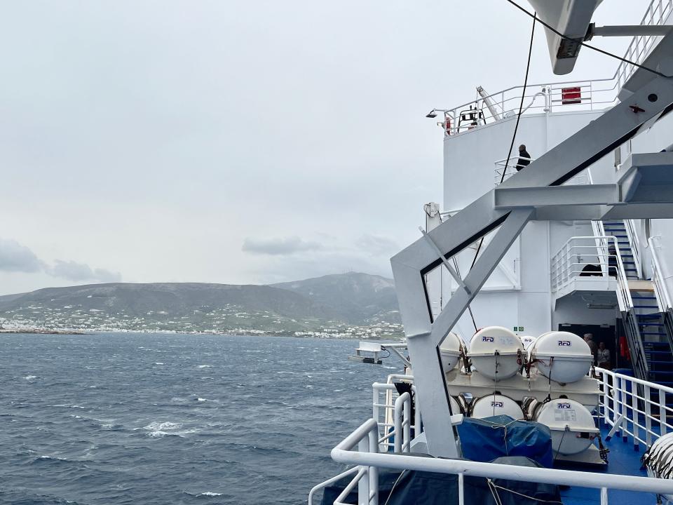 photos of a ferry in the water taken from the perspective of someone on the back deck