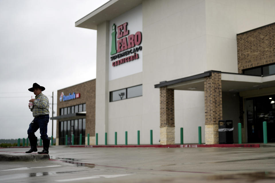 A customer leaves the El Faro Supermercado, which opened earlier this year, in the Santa Fe subdivision of the Colony Ridge development Tuesday, Oct. 3, 2023, in Cleveland, Texas. The booming Texas neighborhood is fighting back after Republican leaders took up unsubstantiated claims that it has become a magnet for immigrants living in the U.S. illegally and that cartels control pockets of the neighborhood. (AP Photo/David J. Phillip)