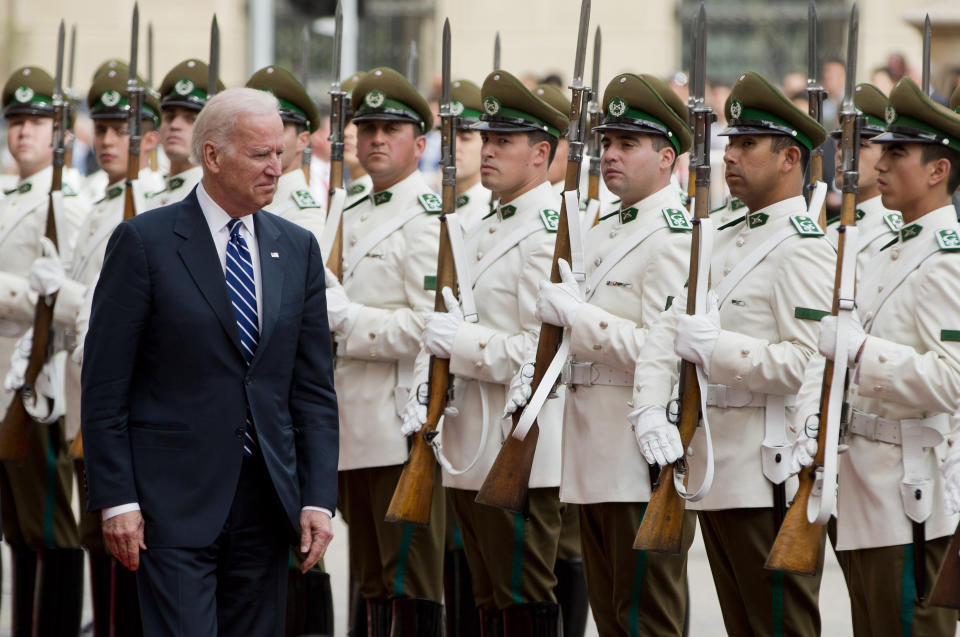 Vice President Joe Biden walks past the honor guard at Moneda Palace in Santiago, Chile, Monday, March 10, 2014. Biden traveled to Chile to attend Tuesday's swearing-in of Michelle Bachelet as Chile's president. (AP Photo/Victor R. Caivano)