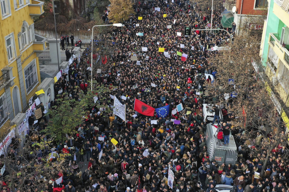 Albania University students protest outside the Education Ministry in Tirana, Tuesday, Dec. 11, 2018. Student demands include cutting tuition fees in half, doubling the budget for education and a greater student presence on decision-making boards. (AP Photo/ Hektor Pustina)