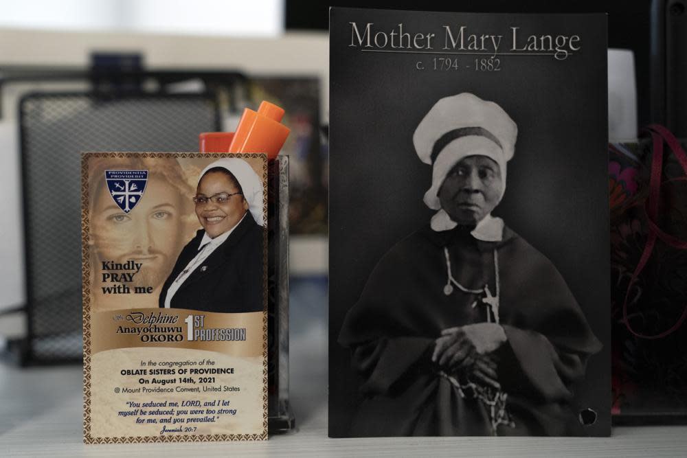 A picture of Mother Mary Lange, the founder of the order of the Oblate Sisters of Providence (OSP), is seen next to a card of Sister Delphine Okoro, a nun with the Oblate Sisters of Providence, in a fifth grade classroom at Mother Mary Lange Catholic School in Baltimore, Wednesday, April 27, 2022. (AP Photo/Jacquelyn Martin)