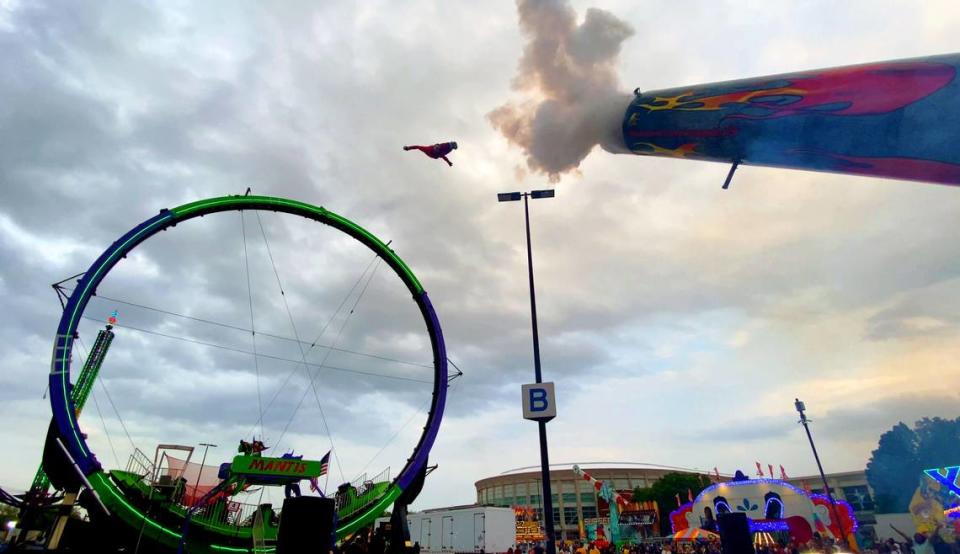 David Smith Jr., a second generation human cannonball known as “The Bullet,” is shot from a cannon Tuesday night at the Spring Fling carnival at the Columbus Civic Center in Columbus. 04/02/2024 Mike Haskey/mhaskey@ledger-enquirer.com