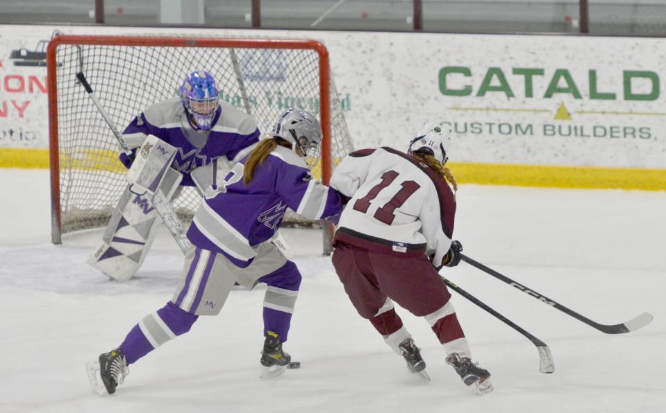Martha's Vineyard's Marin Gillis, left, tries to block a first period goal attempt by Falmouth's Casey Roth.
(Photo: Merrily Cassidy/Cape Cod Times)
