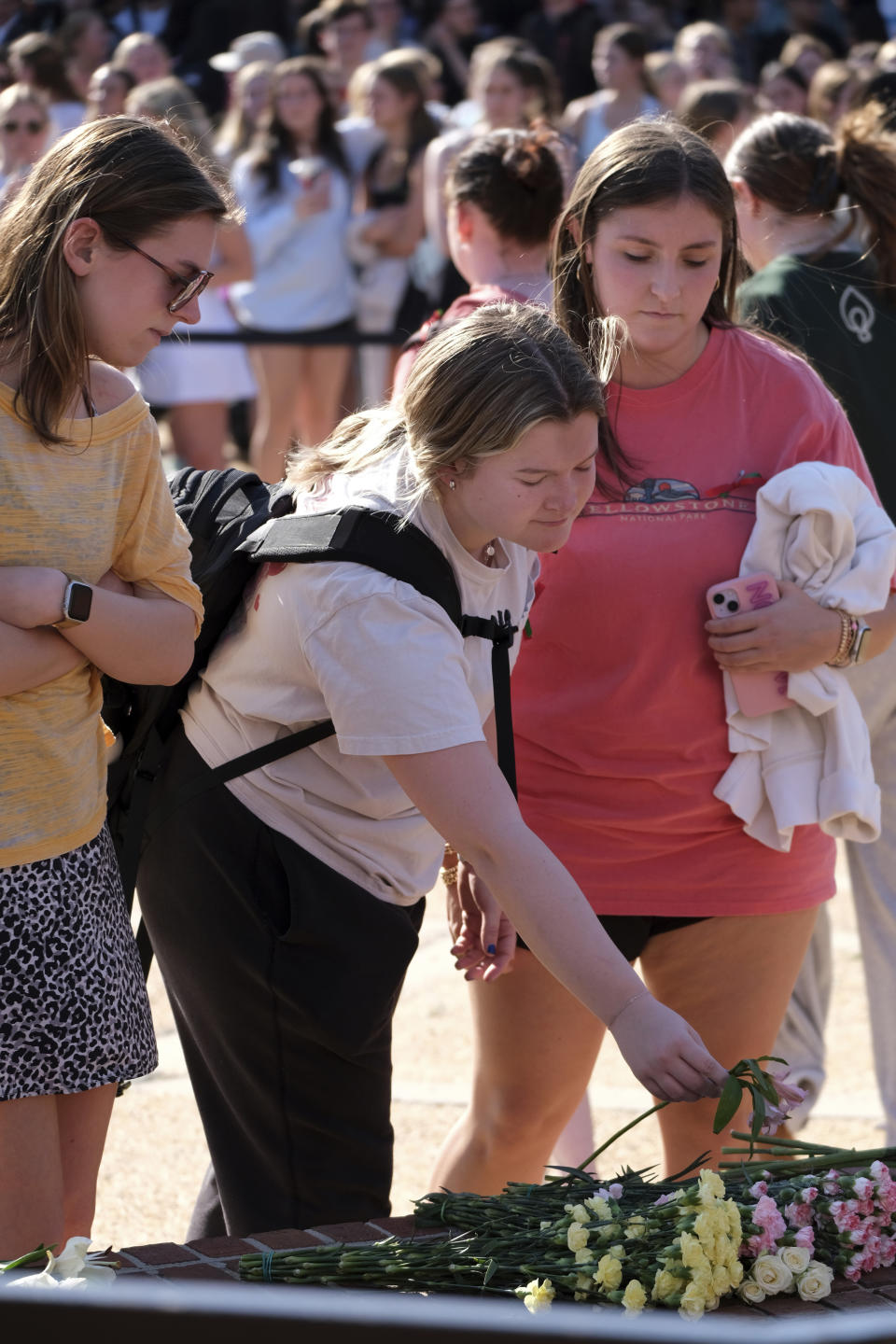 Students gather at the Tate Plaza on the University of Georgia campus in Athens, Ga., Monday, Feb. 26, 2024, to pay tribute to Laken Riley, a nursing student at Augusta University's Athens campus who was found dead Thursday, Feb. 22, after a roommate reported she didn't return from a morning run in a wooded area of the UGA campus near its intramural fields. UGA students also gathered to pay tribute to a student who committed suicide last week. (Nell Carroll/Atlanta Journal-Constitution via AP)