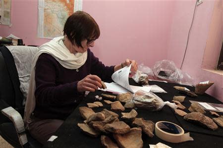 Archaeologist Jane Moon works in her office at the Ziggurat of Ur ruins near Nassiriya, 300 km (186 miles) southeast of Baghdad, January 23, 2014. REUTERS/Ahmed Saad