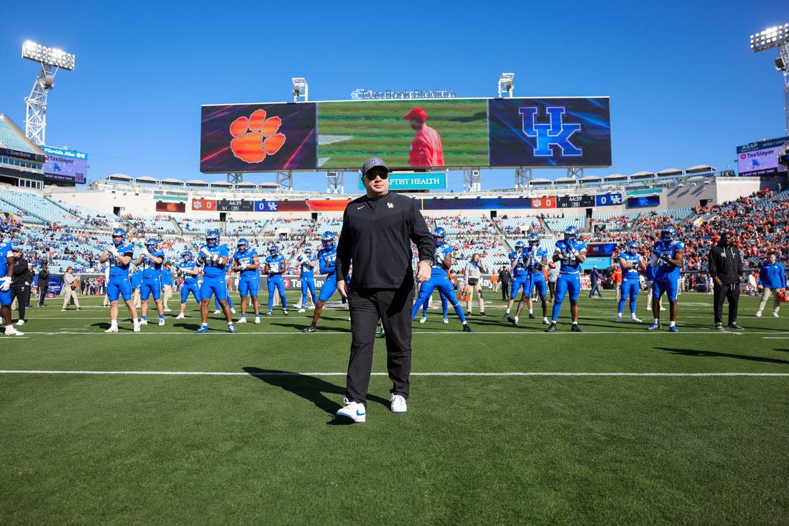 Kentucky football coach Mark Stoops walks on the field ahead of his team’s game against Clemson in the Gator Bowl in Jacksonville, Florida, on Friday.