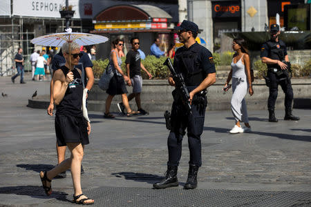 A Spanish riot police officer stands at Puerta del Sol square, In Madrid, Spain August 18, 2017. REUTERS/Juan Medina
