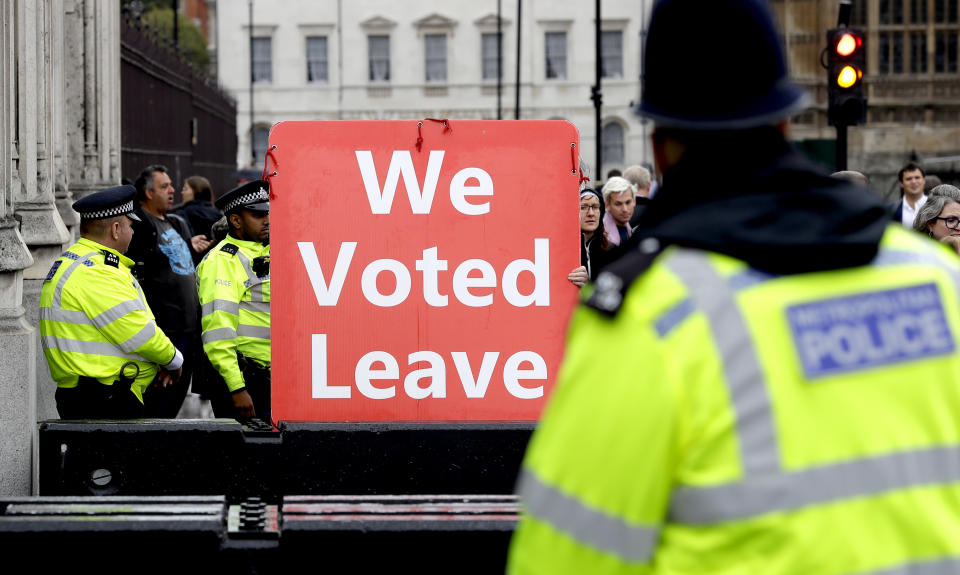 A pro-brexit campaigner holds a banner near Parliament in London, Monday, Sept. 9, 2019. British Prime Minister Boris Johnson voiced optimism Monday that a new Brexit deal can be reached so Britain leaves the European Union by Oct. 31. (AP Photo/Kirsty Wigglesworth)