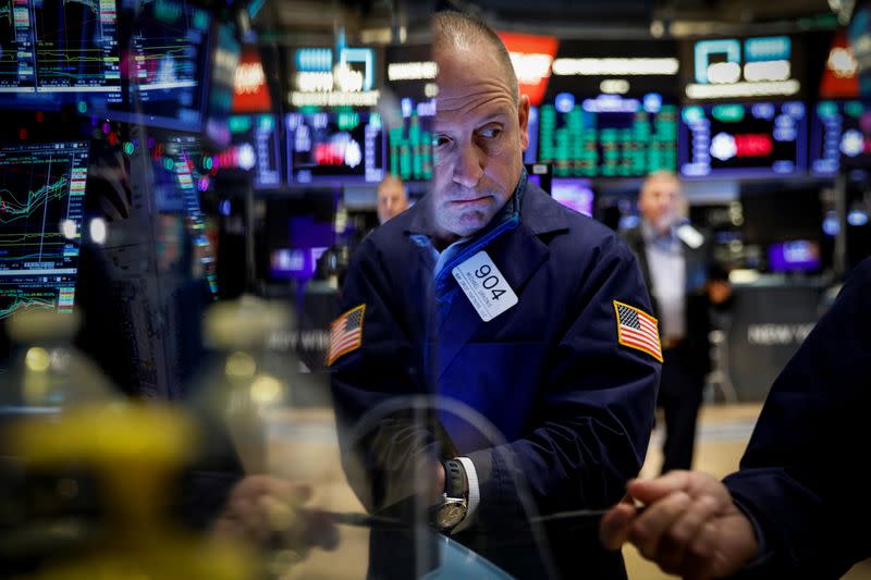 FILE PHOTO: Traders work on the floor of the NYSE in New York