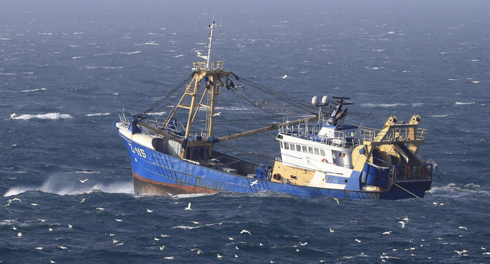 A fishing boat at work in the English Channel, off the southern coast of England, Saturday Feb. 1, 2020. The fishing industry if one of the main subjects for negotiations, after the UK left the European Union on Friday, ending 47 years of close and sometimes uncomfortable ties to Brussels. (Gareth Fuller/PA via AP)