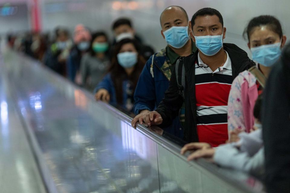 Commuters wear face masks in the Mass Transit Railway (MTR) in Hong Kong: EPA