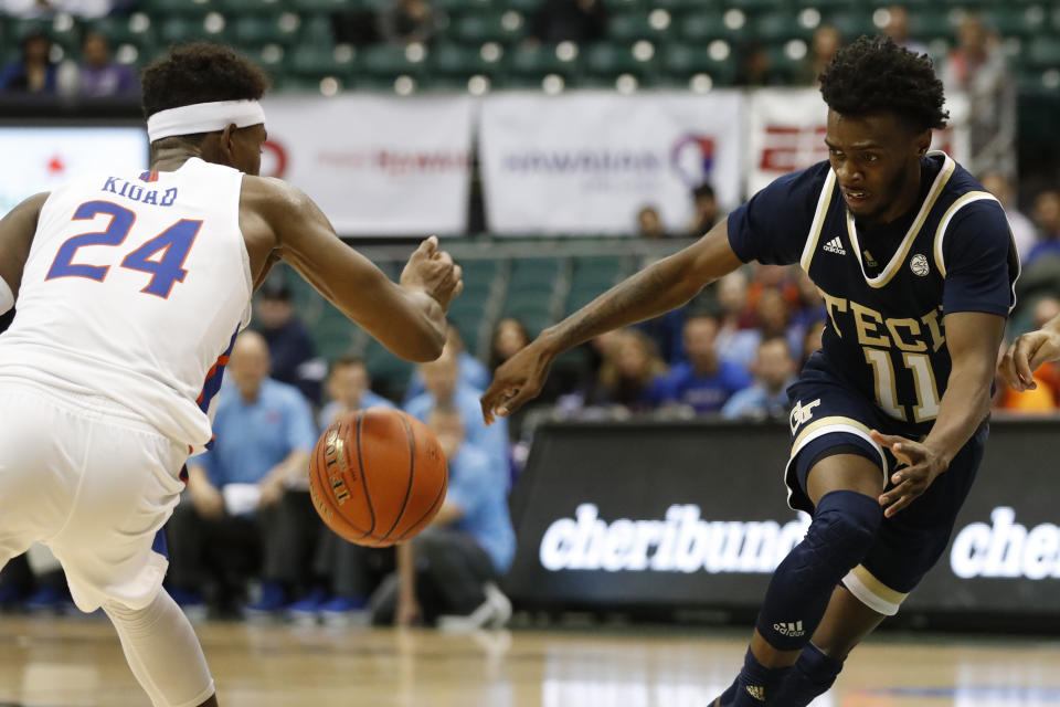 Boise State forward Abu Kigab (24) strips the ball away from Georgia Tech guard Bubba Parham (11) during the second half of an NCAA college basketball game Sunday, Dec. 22, 2019, in Honolulu. (AP Photo/Marco Garcia)