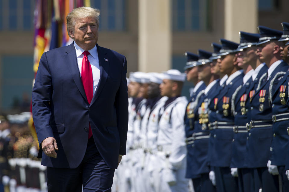 FILE - In this July 25, 2019, file photo, President Donald Trump reviews the troops during a full honors welcoming ceremony for Secretary of Defense Mark Esper at the Pentagon in Washington. If there was one day that crystallized all the forces that led to the impeachment investigation of President Donald Trump, it was July 25. That was the day of his phone call with Ukraine’s new leader, pressing him for a political favor. (AP Photo/Alex Brandon, File)