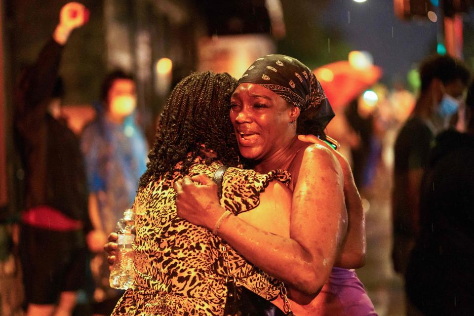 Shawanda Hill, right, the girlfriend of George Floyd reacts near the spot where he died while in custody of the Minneapolis Police, on May 26, 2020 in Minneapolis, Minn.