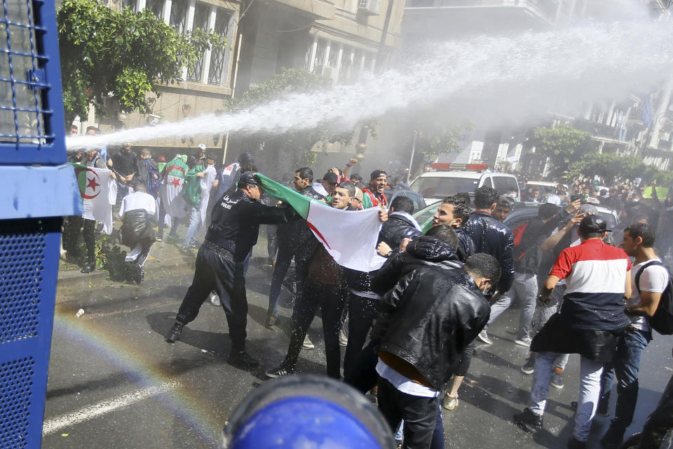 Algerian police forces use a water cannon as students demonstrate in Algiers, Tuesday, April 9, 2019. Algerian police have fired tear gas and water cannon to break up a group of students protesting in the country's capital, less than an hour after the country's parliament chose an interim leader. (AP Photo/Anis Belghoul)