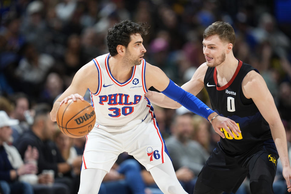 Philadelphia 76ers guard Furkan Korkmaz, left, looks to pass the ball as Denver Nuggets guard Christian Braun defends in the second half of an NBA basketball game, Saturday, Jan. 27, 2024, in Denver. (AP Photo/David Zalubowski)