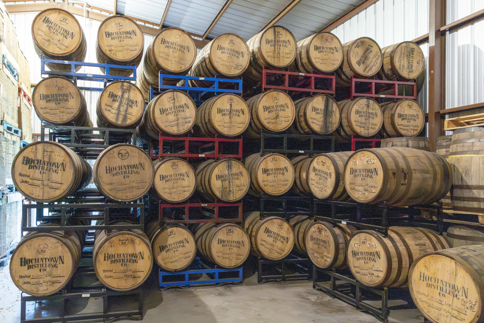 Barrels of bourbon are stacked at the Hochatown Distilling Company in Broken Bow, Okla. on Thursday, April 20, 2023. The growing optimism of McCurtain County's tourism boom over the last two decades took a gut punch last week when the local newspaper identified several county officials, including the sheriff and a county commissioner, who were caught on tape discussing killing journalists and lynching Black people. (AP Photo/Alonzo Adams)