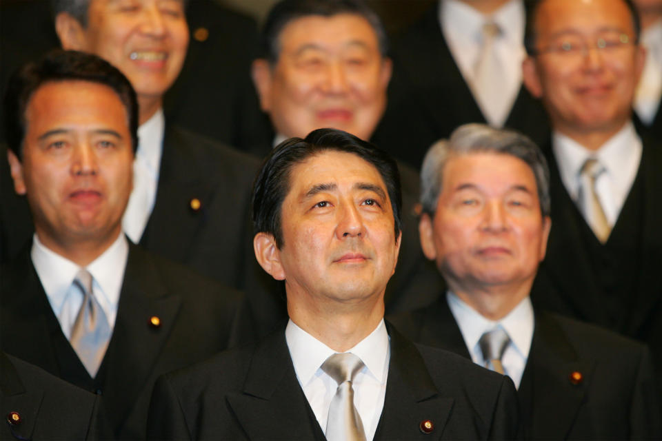 FILE - Newly-appointed Japanese Prime Minister Shinzo Abe, center, poses with his Cabinet members for the official group photo at the prime minister's official residence in Tokyo on Sept. 26, 2006. (AP Photo/Koji Sasahara, File)