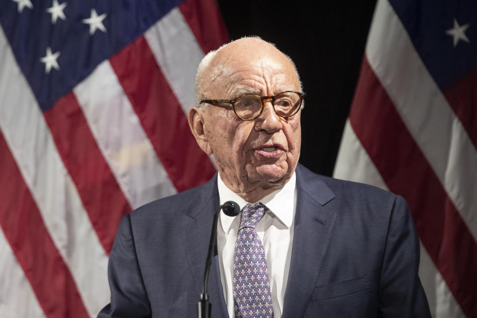 FILE - Rupert Murdoch introduces Secretary of State Mike Pompeo during the Herman Kahn Award Gala, in New York, Oct. 30, 2018. Tucker Carlson, Sean Hannity and Bret Baier are among the stars that both Fox News and the voting machine company suing it for defamation have signaled could testify if the explosive case heads to trial next month.(AP Photo/Mary Altaffer, File)