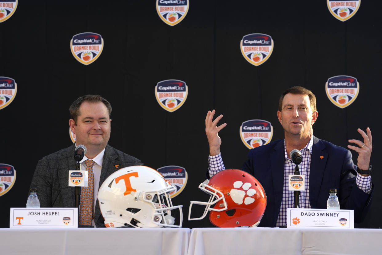 Tennessee head coach Josh Heupel, left, and Clemson head coach Dabo Swinney, right, speak during a news conference for the Orange Bowl NCAA college football game, Wednesday, Dec. 7, 2022, in Hollywood, Fla. The two teams will play in the Orange Bowl on Dec. 30. (AP Photo/Lynne Sladky)