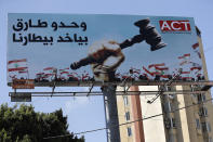 An Arabic billboard set on a highway supports Judge Tarek Bitar, the lead investigator in last year's deadly seaport blast, reads: "Only Tarek (Bitar) can take our revenge," in Beirut, Lebanon, Wednesday, Sept. 22, 2021. For eight months Bitar, a relatively obscure judge has quietly investigated one of the world's worst non-nuclear explosions with only two assistants helping him -- and a lot of powerful detractors blocking him. For many Lebanese Bitar is their only hope for truth and accountability in a country that craves both. But for the country's entrenched political class, the 47-year-old Bitar has become a nightmare that needs to be dealt with. (AP Photo/Hussein Malla)