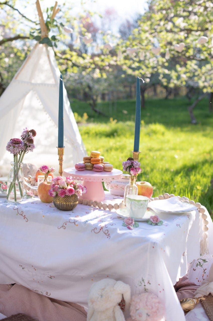 Megan Petrus arranged this elegant picnic site for a tea party at an apple orchard. Sunrise Picnics, a new business that Petrus has started, specializes in setting scenes for clients and helping them create "core moments" in their lives.