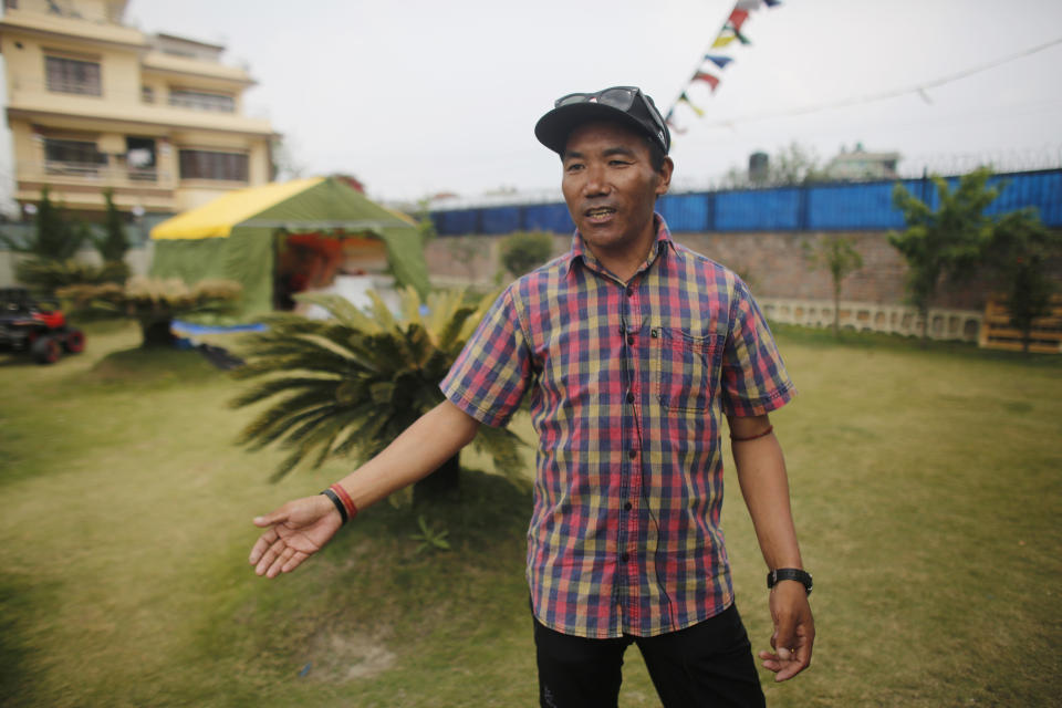 In this April 4, 2019 photo, record holding Sherpa guide Kami Rita speaks with the Associated Press in Kathmandu, Nepal. Five years after one of the deadliest disasters on Mount Everest, three people from Nepal's ethnic Sherpa community, including Rita, are preparing an ascent to raise awareness about the Nepalese mountain guides who make it possible for hundreds of foreign climbers to scale the mountain and survive. Rita, who lived through the 2014 ice avalanche on Everest’s western shoulder that killed 16 fellow Sherpa guides, aims to break his own record by reaching the mountaintop a 23rd time this spring. (AP Photo/Niranjan Shrestha)