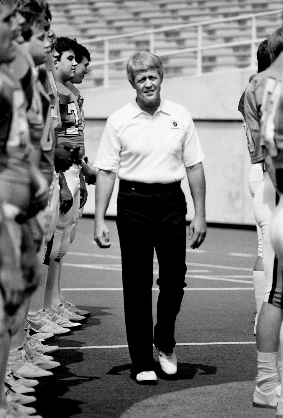 Vanderbilt head football coach George MacIntyre moves through the Commodore squad, which was lined up for an official team picture at Dudley Field on Aug. 18, 1983.