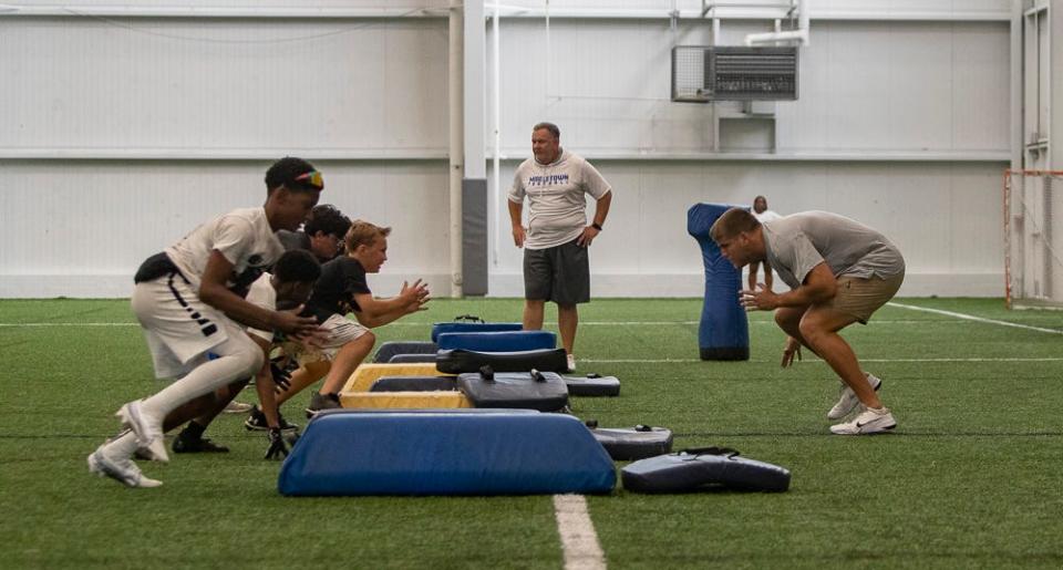 Brian O'Neill (right) of the Minnesota Vikings leads drill at a free NFL clinic for youths at Chase Fieldhouse in Wilmington on Friday, June 17, 2022.