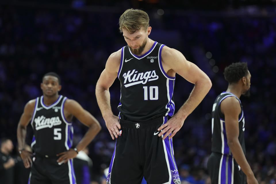 PHILADELPHIA, PENNSYLVANIA - JANUARY 12: Domantas Sabonis #10, De'Aaron Fox #5, and Malik Monk #0 of the Sacramento Kings look on against the Philadelphia 76ers at the Wells Fargo Center on January 12, 2024 in Philadelphia, Pennsylvania. NOTE TO USER: User expressly acknowledges and agrees that, by downloading and or using this photograph, User is consenting to the terms and conditions of the Getty Images License Agreement. (Photo by Mitchell Leff/Getty Images)