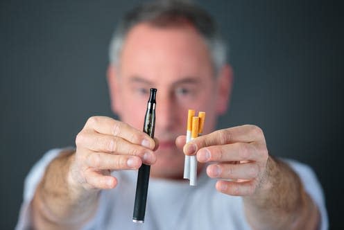 <span class="caption">Concerns about Evali may be preventing some from switching to e-cigarettes to quit smoking.</span> <span class="attribution"><a class="link " href="https://www.shutterstock.com/image-photo/man-holding-vaporizer-conventional-tobacco-cigarettes-1399249463" rel="nofollow noopener" target="_blank" data-ylk="slk:ALPA PROD/ Shutterstock;elm:context_link;itc:0;sec:content-canvas">ALPA PROD/ Shutterstock</a></span>