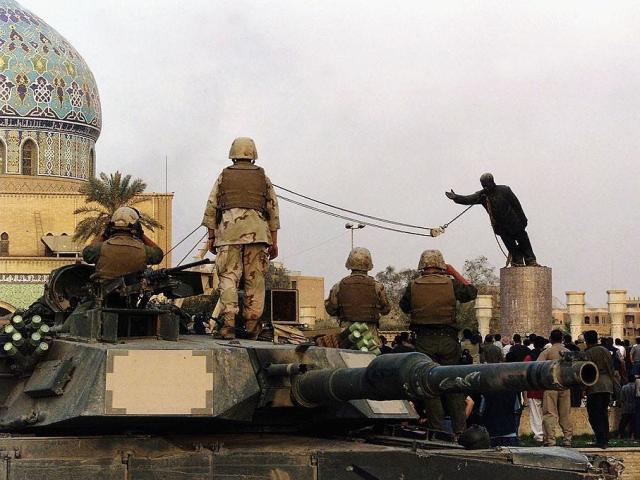 Statue of Saddam Hussein falling.