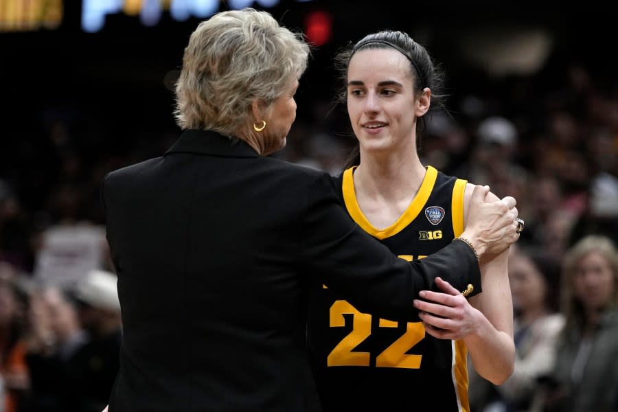 Iowa head coach Lisa Bluder talks with guard Caitlin Clark (22) at the end of the Final Four college basketball championship game against South Carolina in the women's NCAA Tournament, Sunday, April 7, 2024, in Cleveland. South Carolina won 87-75. (AP Photo/Morry Gash)