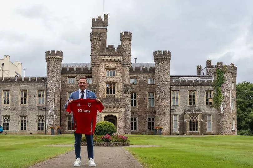 The new Wales Head Coach Craig Bellamy poses for a photograph while holding a Wales football shirt at The Vale Resort -Credit:Getty