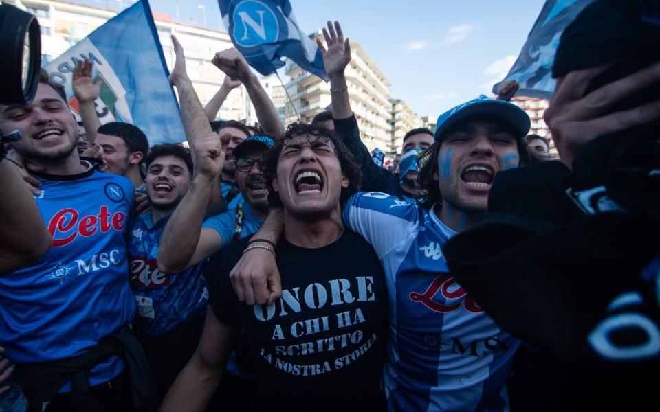 Napoli fans celebrate near the Diego Armando Maradona stadium before watching the live broadcast - Getty Images/Ivan Romano