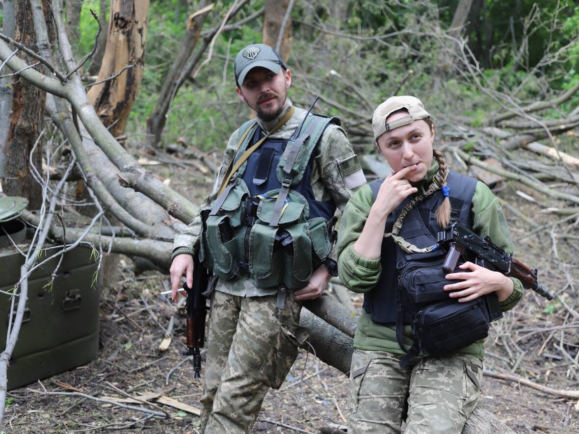 Oksana and Stas Krasnov have fought off Russian assaults on the Izyum front for the past month. They left their jobs as lawyers in Kyiv to join the fight.  (Neil Hauer/CBC - image credit)