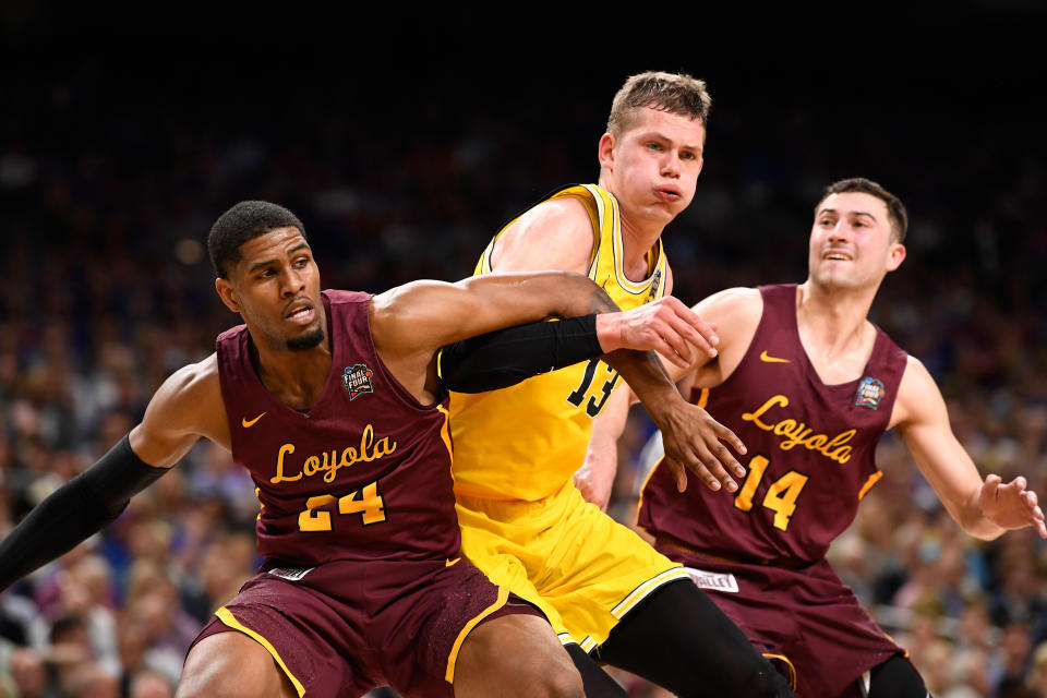 <p>Moritz Wagner #13 of the Michigan Wolverines is boxed out by Aundre Jackson #24 and Ben Richardson #14 of the Loyola Ramblers during the second half in the 2018 NCAA Men’s Final Four semifinal game at the Alamodome on March 31, 2018 in San Antonio, Texas. (Photo by Jamie Schwaberow/NCAA Photos via Getty Images) </p>