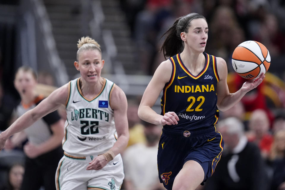 Indiana Fever guard Caitlin Clark drives up court ahead of New York Liberty guard Courtney Vandersloot, left, in the second half of a WNBA basketball game, Thursday, May 16, 2024, in Indianapolis. (AP Photo/Michael Conroy)