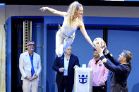 A performer hands a soccer ball to Icon of the Seas Captain Henrik Loy, right, as Inter Miami soccer player Lionel Messi, second from right, looks on during a naming ceremony for Royal Caribbean International's new cruise ship, Icon of the Seas, Tuesday, Jan. 23, 2024, in Miami. Inter Miami CF has formed a partnership with the cruise line Royal Caribbean International. (AP Photo/Lynne Sladky)