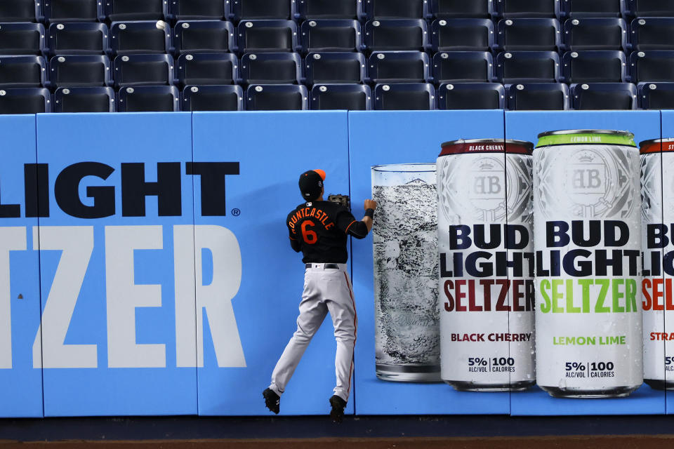 Baltimore Orioles left fielder Ryan Mountcastle can only watch as a three-run home run by New York Yankees' Luke Voit falls into the seats during the fifth inning of the second baseball game of a doubleheader Friday, Sept. 11, 2020, in New York. (AP Photo/Adam Hunger)