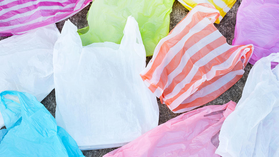 Colorful plastic waste on cement floor background