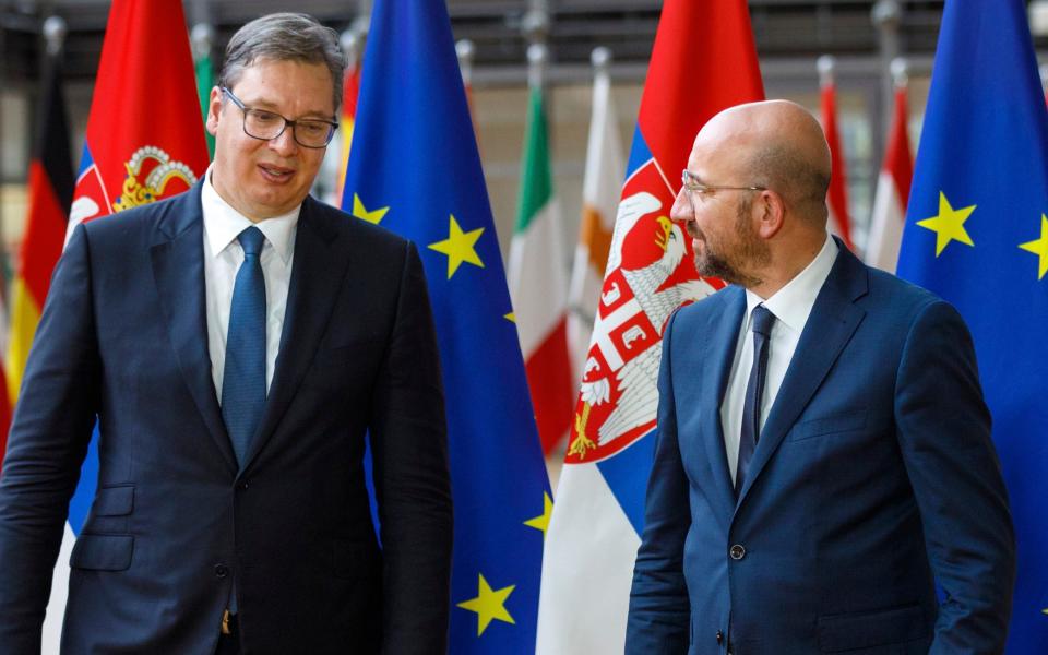 European Council President Charles Michel, right, greets Serbian President Aleksandar Vucic prior to a meeting at the European Council building in Brussels - AP Pool